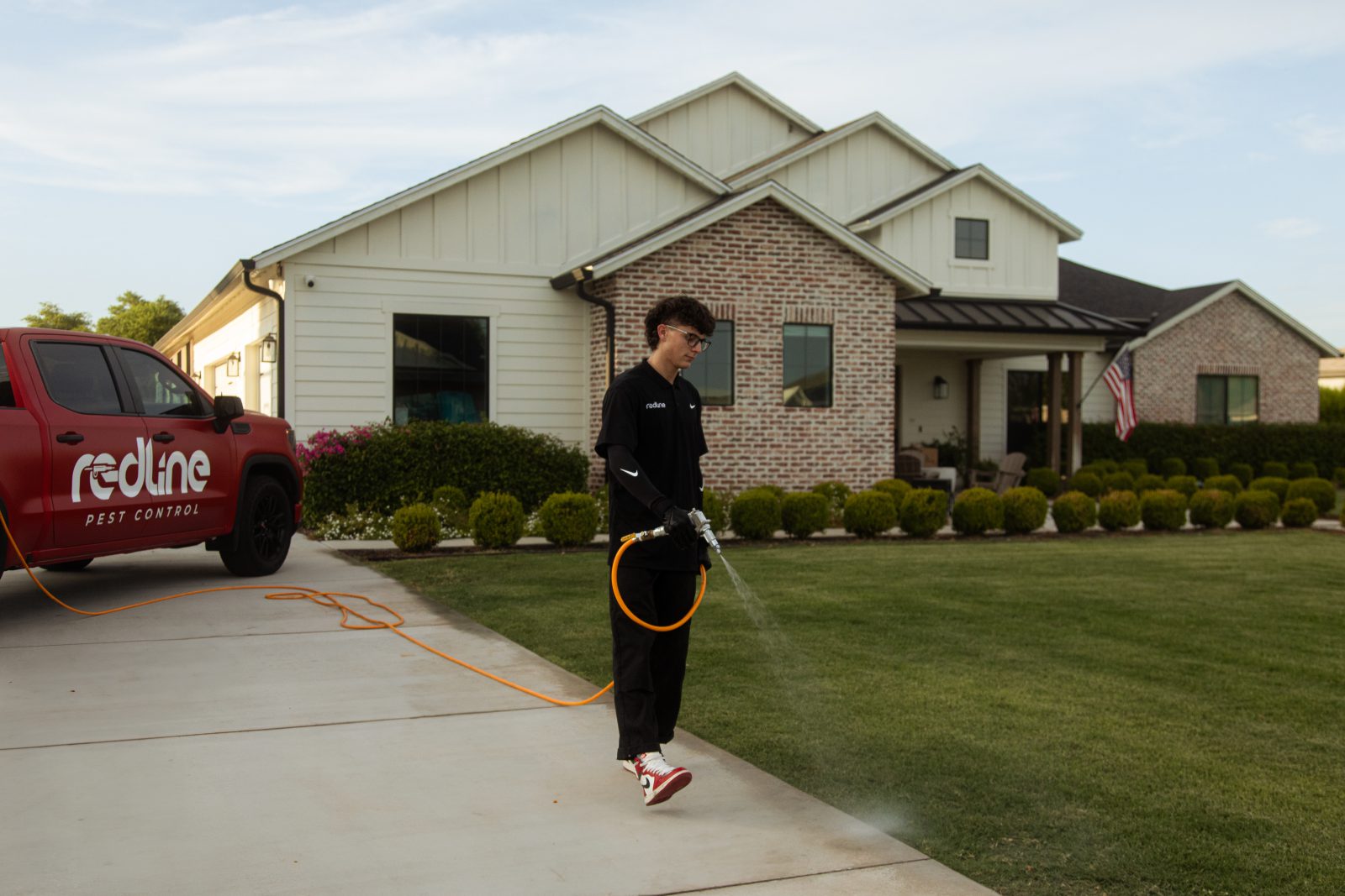 Redline technician servicing an Arizona home with the company truck