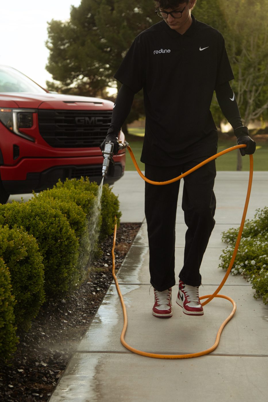 Redline technician treating the perimeter of an Arizona home