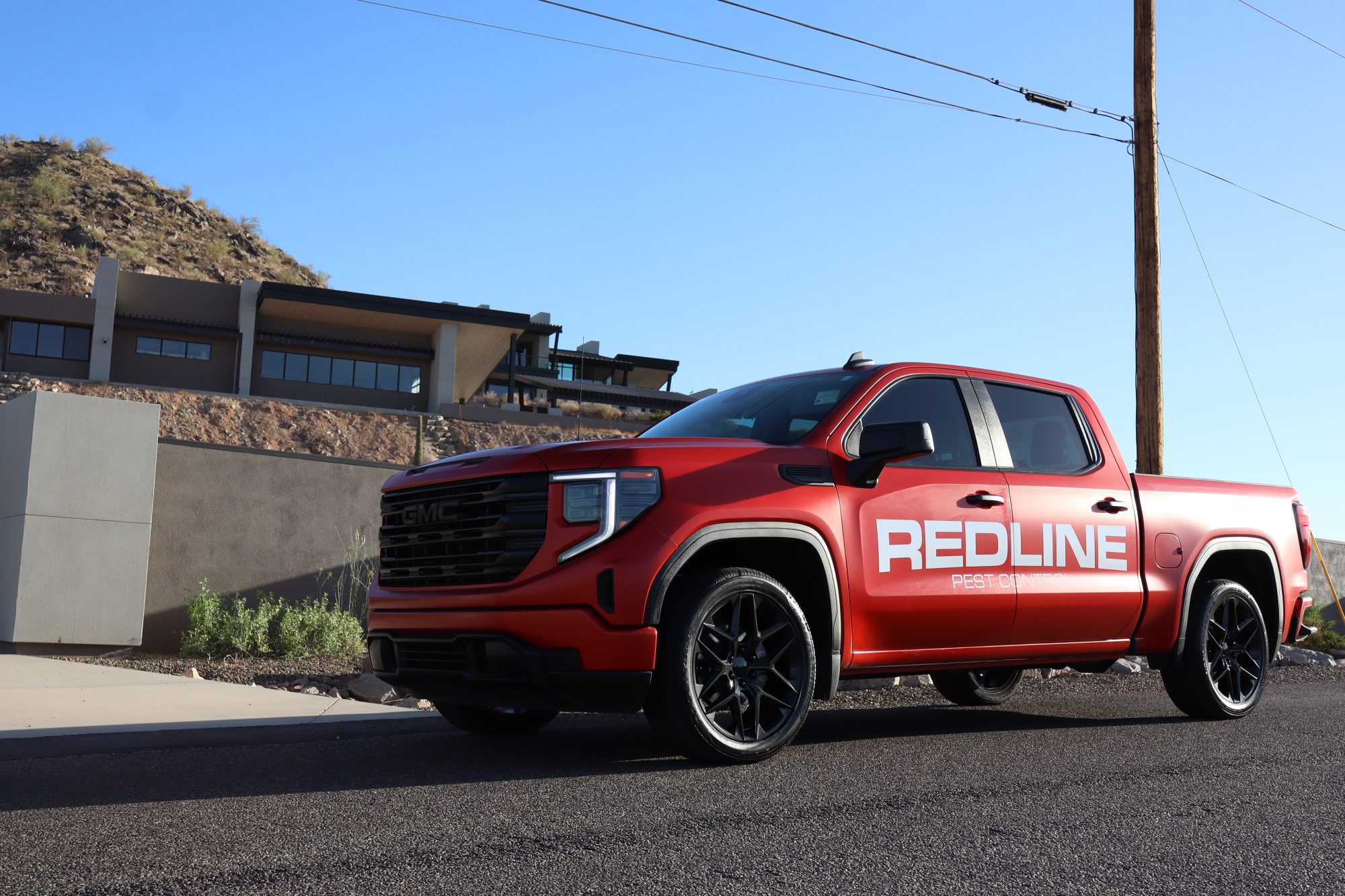 Redline Pest Control truck in the Arizona desert at golden hour